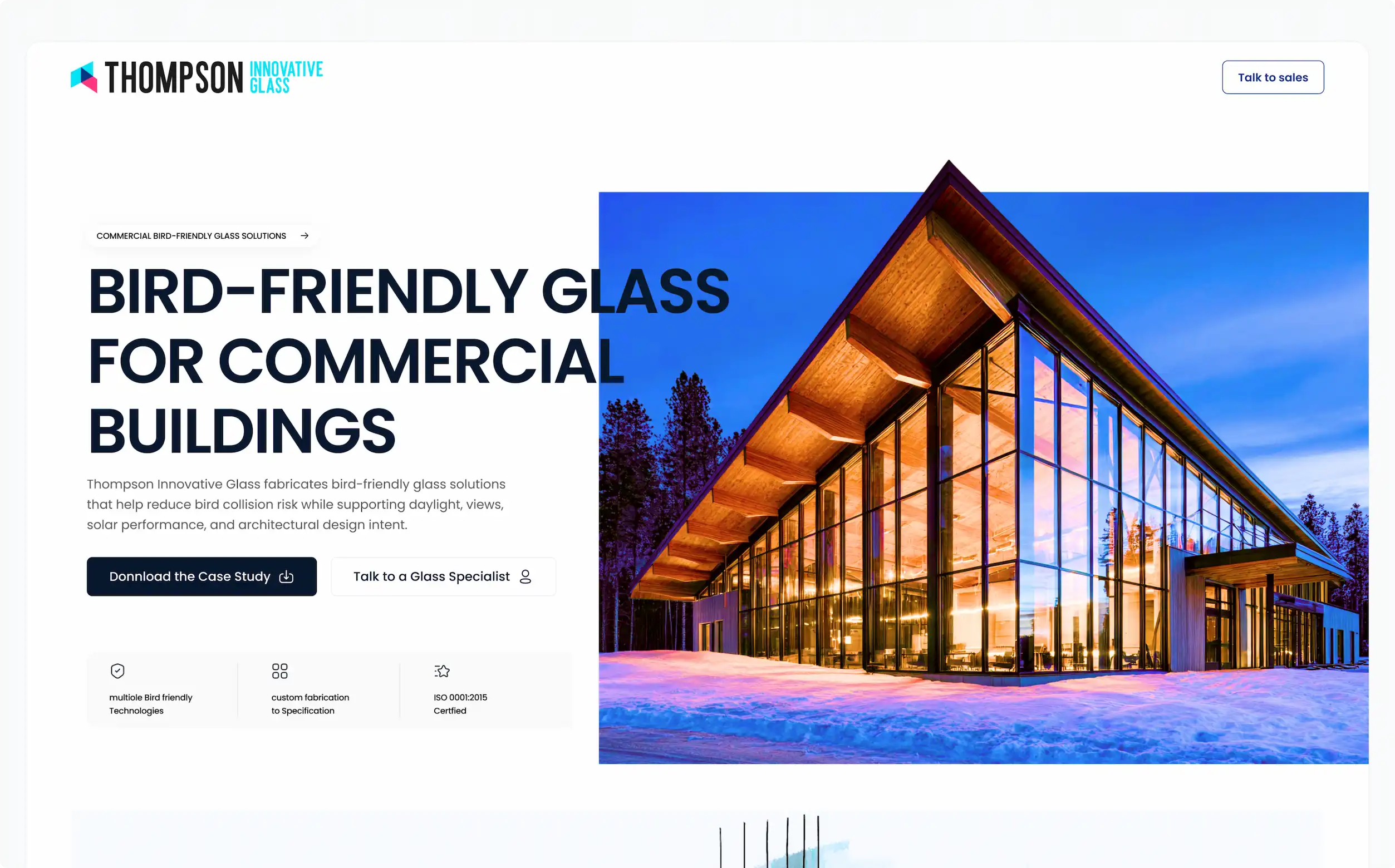Bird-friendly glass facade on a commercial building at dusk, showcasing Thompson Innovative Glass's custom fabrication and solar performance.